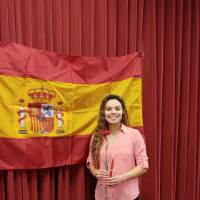 Alyssa Flores posing in front of Spanish flag